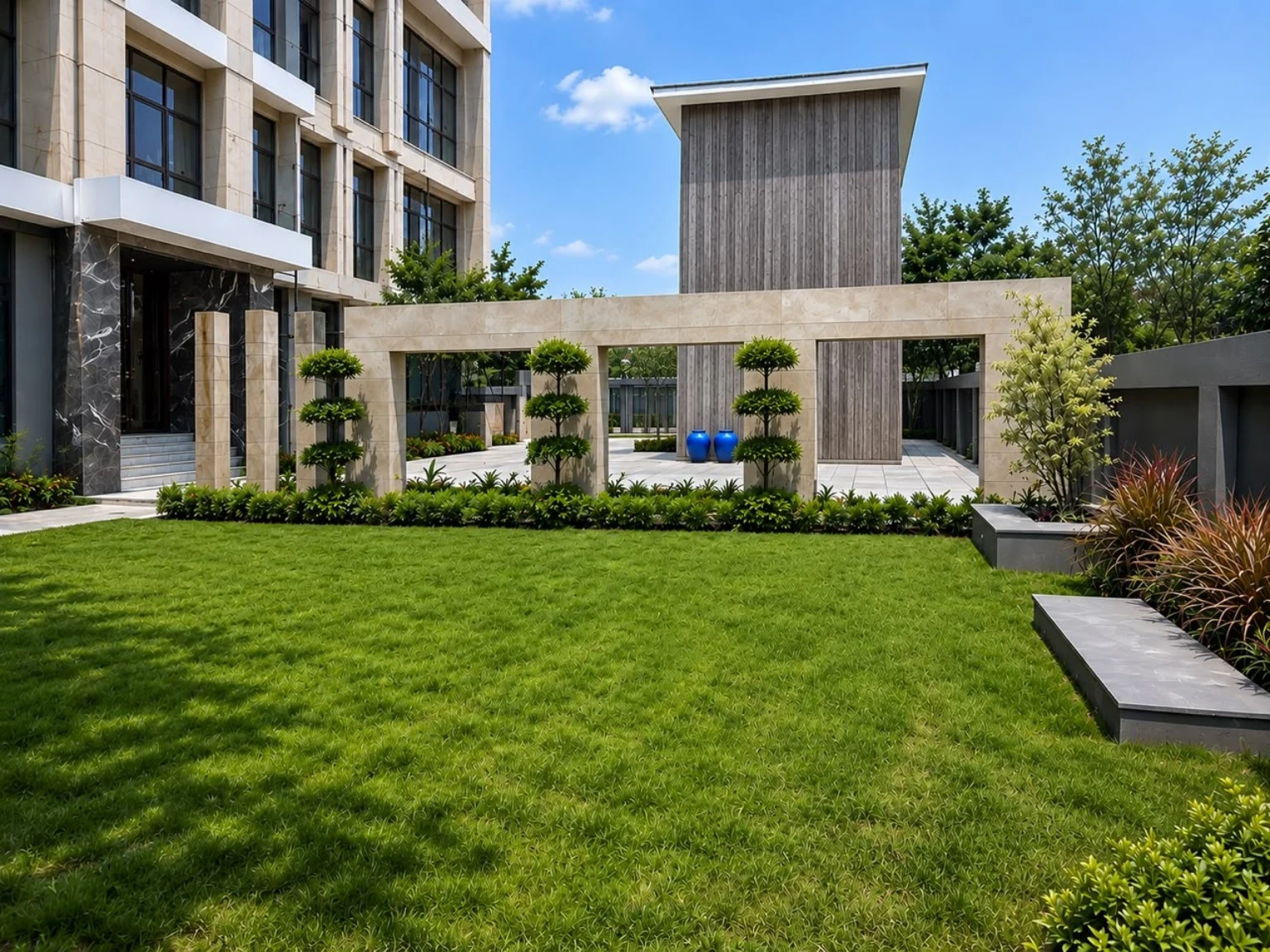 A lush landscaped lawn framed by modern architecture and tropical planting