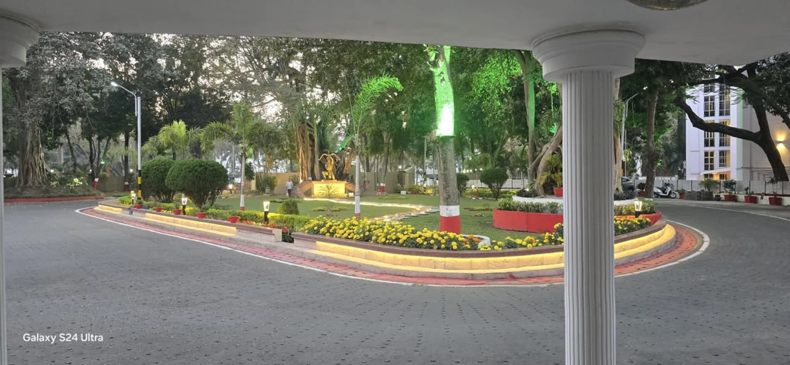 Landscaped grounds with greenery and evening lighting