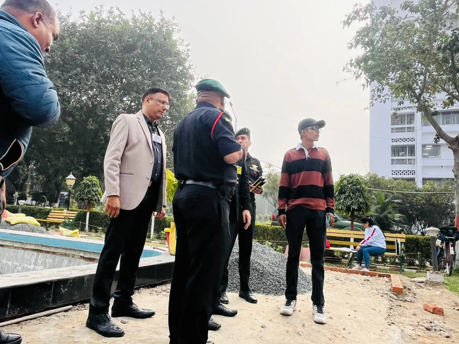A group discussing a landscape area during a site visit